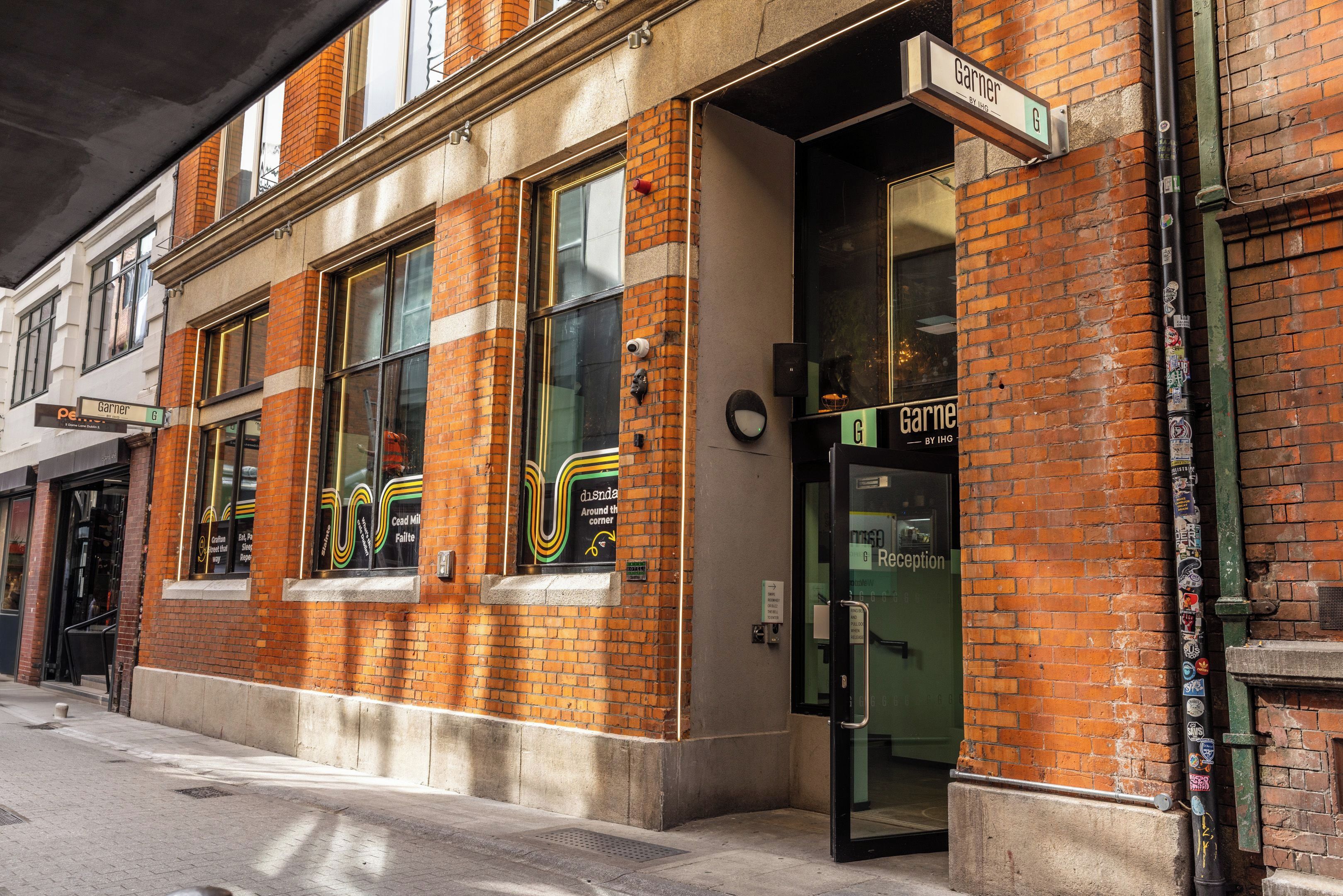 A brick building with a glass door entrance labeled 'Reception'.