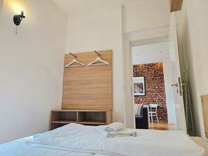 Enjoy a bright and welcoming space with a neatly made bed, dining area, and ample storage.