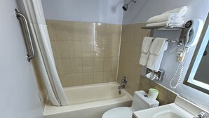 A small bathroom with a bathtub, toilet, and sink.