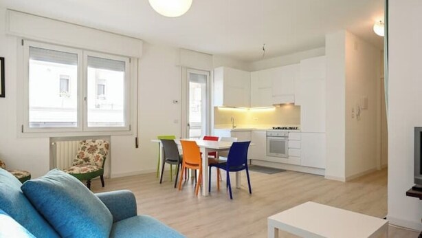 Un appartement moderne comprenant un salon, un coin repas et une cuisine.