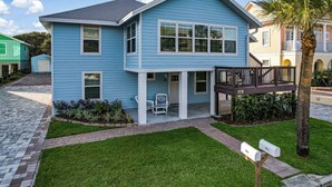A two-story house with a covered porch, a mailbox, and a small garden area. - The Entire Coastal Blue Bliss with heated POOL (Fernandina Beach)