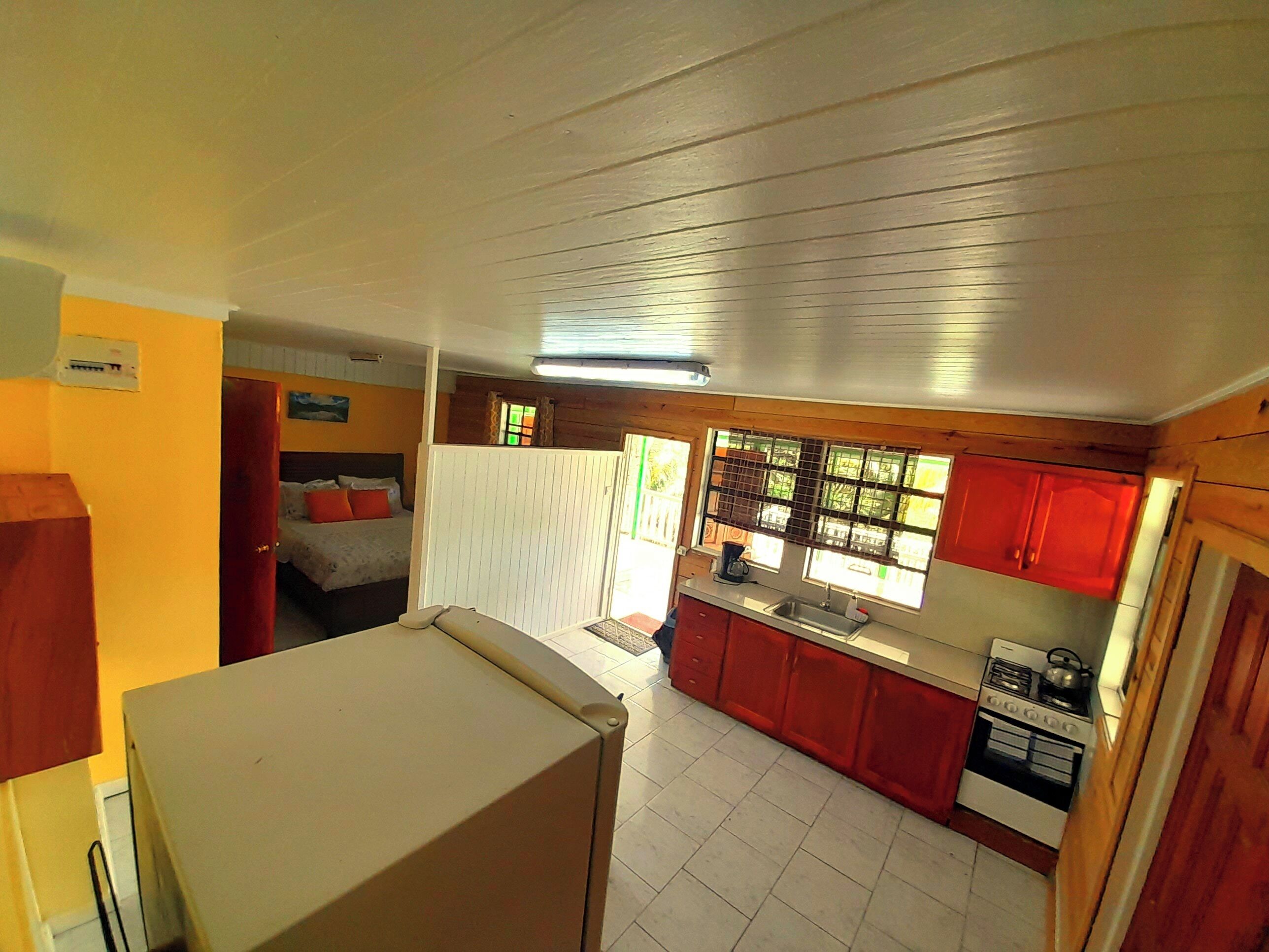 A compact kitchen with a stove, sink, and a small countertop.