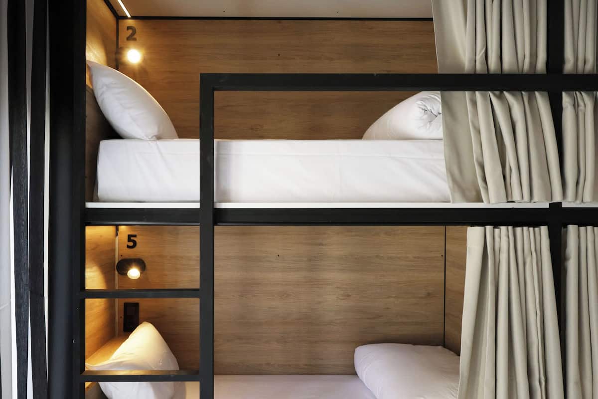 A bunk bed with wooden frames and numbered compartments.
