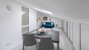 A modern dining area with a glass-top table, two chairs, and a decorative centerpiece. - Maisonnette Il Todeschino B12 by Wonderful Italy (Sirmione)