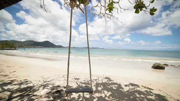 A beach with a swing set, clear sky, and distant mountains. - Félix T2 accès plage à Ste Luce

 (Sainte-Luce)