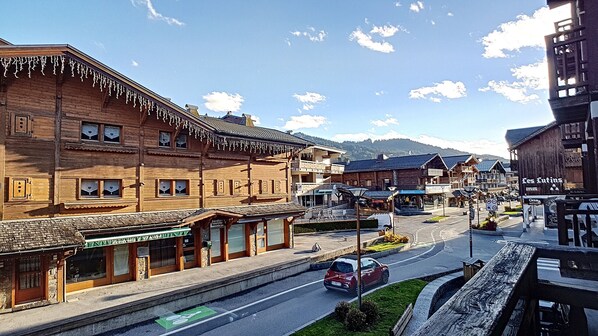 A wooden building with a shop on the ground floor and a restaurant on the second floor.