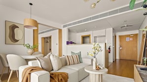 A modern living room with a sofa, a coffee table, and a dining area. - Silkhaus AL Sana 2 - AL Raha (Abu Dhabi)