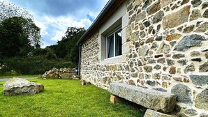 A stone building with a grassy lawn and a stone wall. - House Le Rohel (Pleubian)