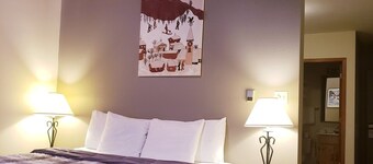 Private King Suite ideal for couples/romantic stays, and single travelers featuring a beautiful knotty pine vaulted ceiling. Dog friendly!