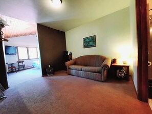 TV - Private couples suite inside the Lodge at North Ironwood Acres resort with knotty-pine vaulted ceiling, one KING bed, sofa and one small bathroom. DOG FRIENDLY!! (Ironwood)