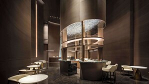 A modern hotel lobby with a central bar area, multiple seating arrangements, and a polished marble floor. - Howard Johnson Royal Hotel Shenzhen (Shenzhen)