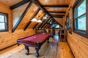 A wooden interior with a pool table, wooden beams, and large windows. - Treehouse- Pet Friendly, Luxury Log Cabin Rental on Creek, Fly-fishing, Hot Tub, Rafting-Nantahala NC (Topton)