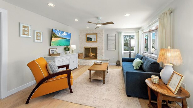 A living room with a sofa, armchair, coffee table, fireplace, and a television. - Cozy Beach Haven Terrace Home, 1 Block From Beach, Restaurants & Wawa! (Long Beach)