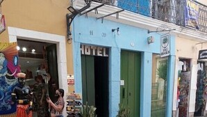 A hotel with a blue facade, a green door, and a signboard. - CASADALUCIA  POUSADA (Salvador)
