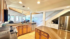 A modern kitchen with wooden cabinets, stainless steel appliances, and a granite countertop. - Sleeps 6, Inground Pool, Amazing Views + More! (Sparta)