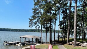 A deck with outdoor furniture, a fire pit, and a view of a lake. - Sleeps 6, Inground Pool, Amazing Views + More! (Sparta)