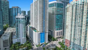 A high-rise building with multiple floors, a prominent blue vertical stripe, and a red location marker. - Zeus Sanctuary in Brickell Miami (Miami)