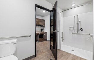 Standard Single Room, 1 Queen Bed (Hearing Impaired Roll In Shower) | Bathroom | Free toiletries, hair dryer, towels, soap