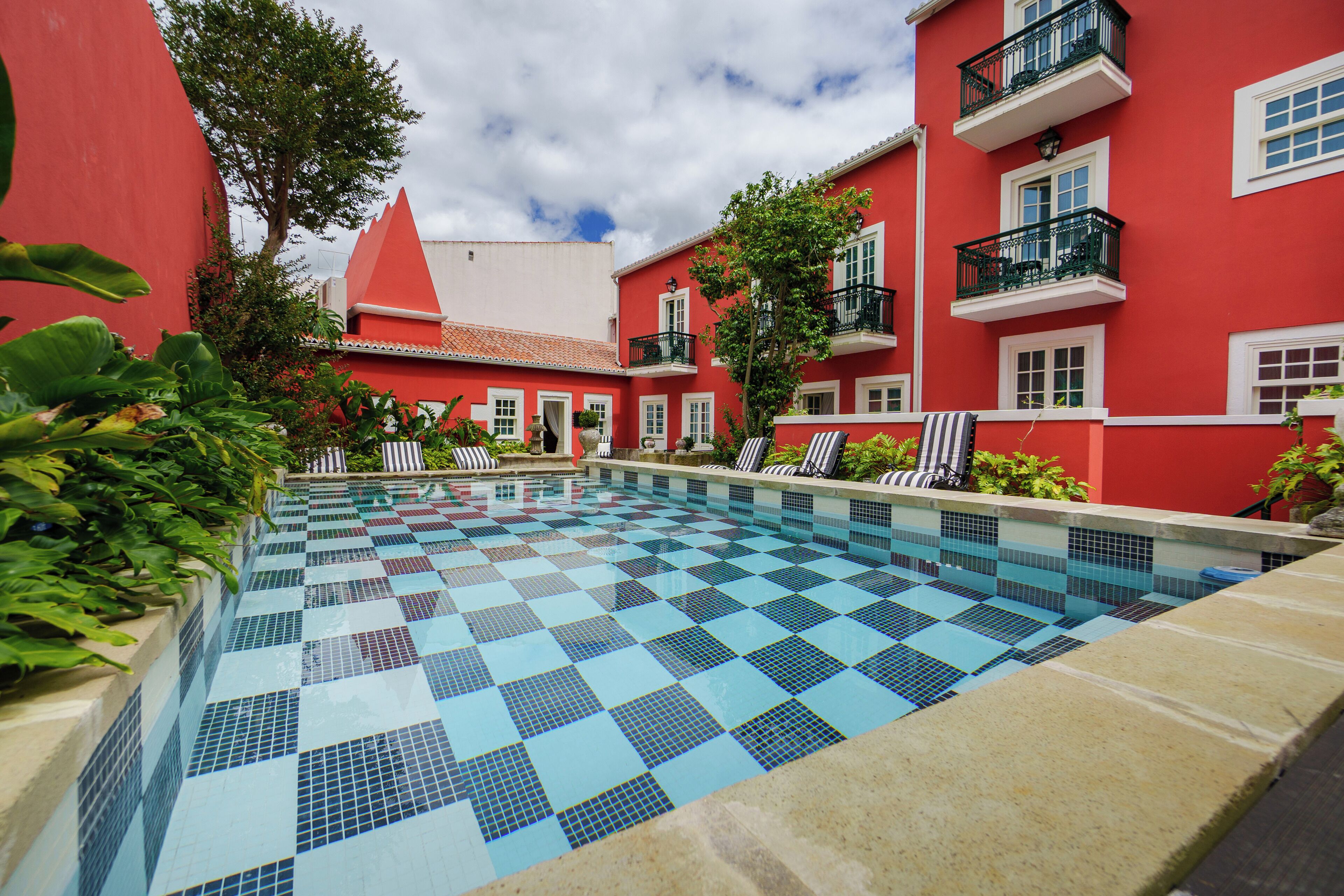 Una piscina al aire libre de temporada, sillones reclinables de piscina