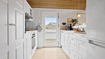 Fridge, stovetop, dishwasher, coffee/tea maker