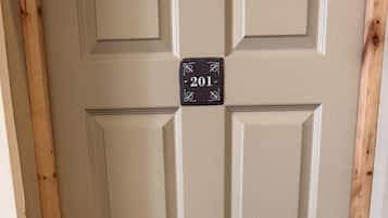 A door with a sign reading 'North View' and a number plate '201'.