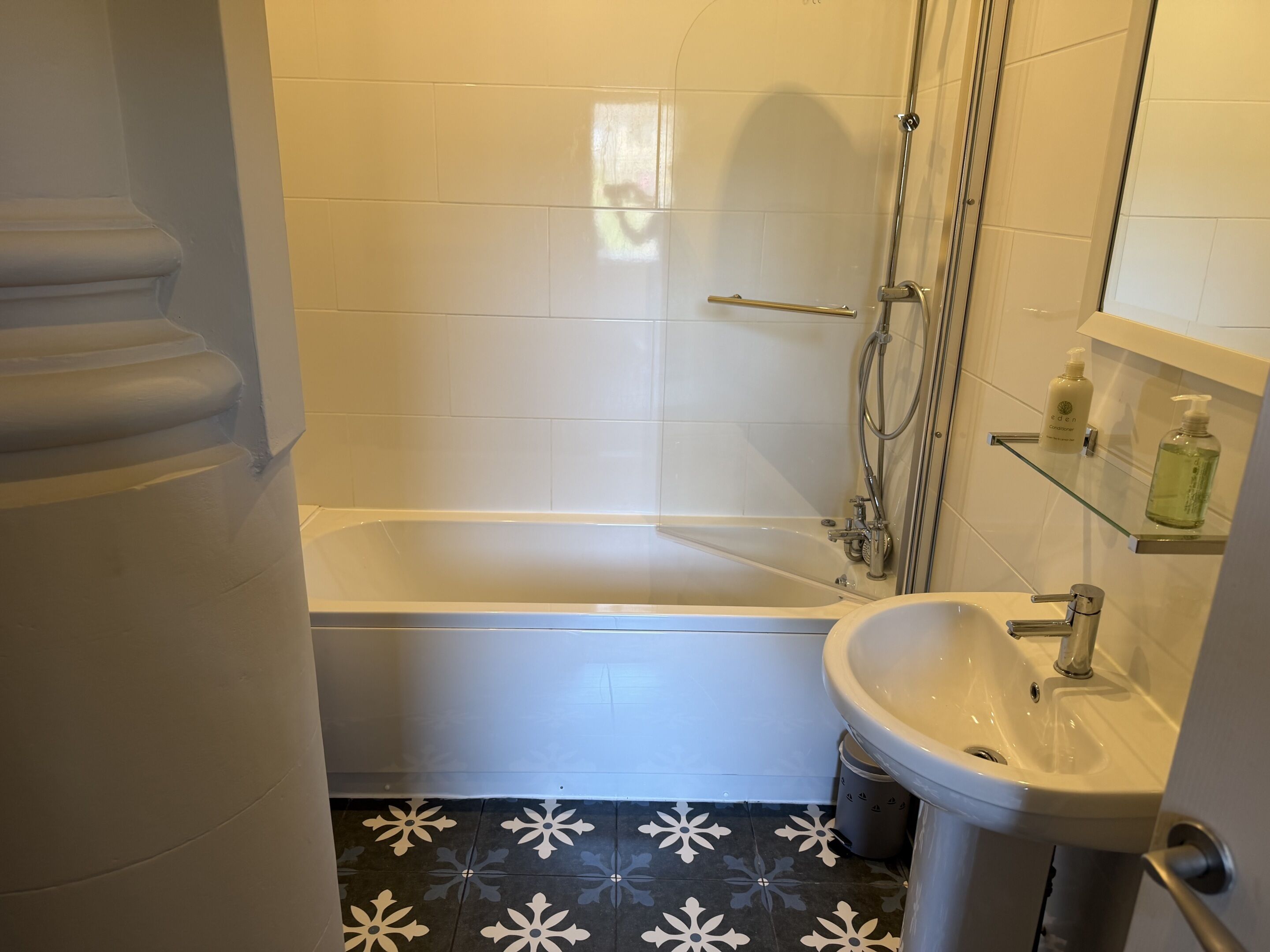 A bathroom with a bathtub, a sink, and a shower.