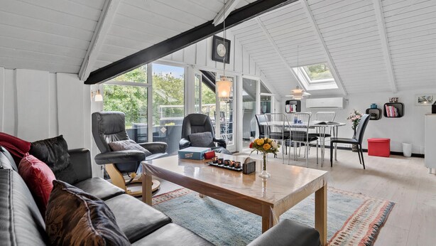 A spacious living area with a high ceiling, a dining area, and large windows providing natural light. - Awesome home in Skjern with WiFi (Skjern)