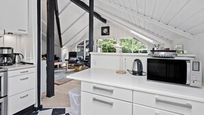 A modern kitchen with white cabinetry, a built-in microwave, and a coffee maker. - Awesome home in Skjern with WiFi (Skjern)