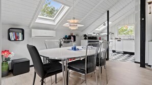 A modern kitchen with white cabinets, a black and white checkered floor, and a skylight above the dining area. - Awesome home in Skjern with WiFi (Skjern)