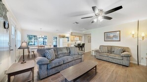 A spacious living area with two sofas, a coffee table, and a ceiling fan. - Lakefront home on Lake Kerr near Salt Springs with large porch and great yard (Salt Springs)