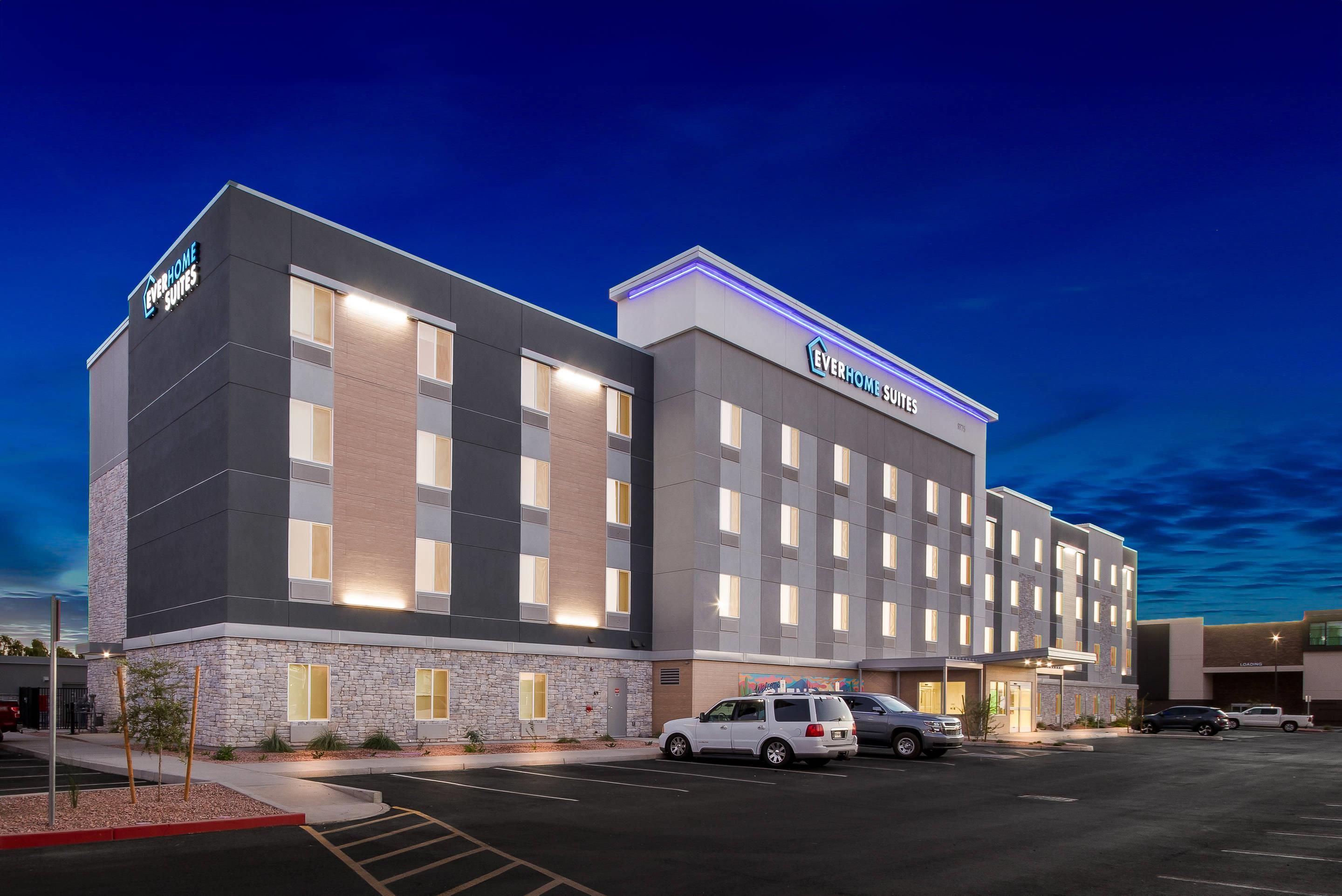 A multi-story hotel with a modern design, featuring a prominent 'Everhome Suites' sign.