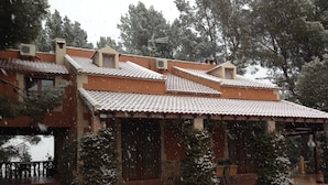 A building with a tiled roof, multiple chimneys, and a covered porch with potted plants. - Country House 'El Pinar De La Loma' with Private Pool, Wi-Fi and Air Conditioning (Moratalla)
