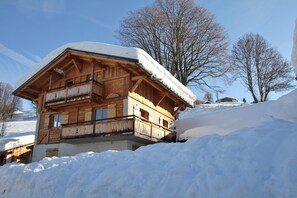 A wooden chalet with a balcony, surrounded by snow. - Chalet 'Le Grépon' with Mountain View, Private Terrace and Wi-Fi (Crest-Voland)