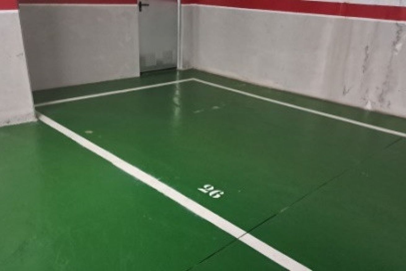 A green indoor space with white walls and a door.
