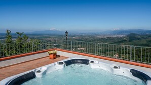 A rooftop terrace with a hot tub, a potted plant, and a view of a cityscape and mountains. - Holiday Home 'Podere Calistri' with Mountain View, Wi-Fi and Air Conditioning (Larciano)