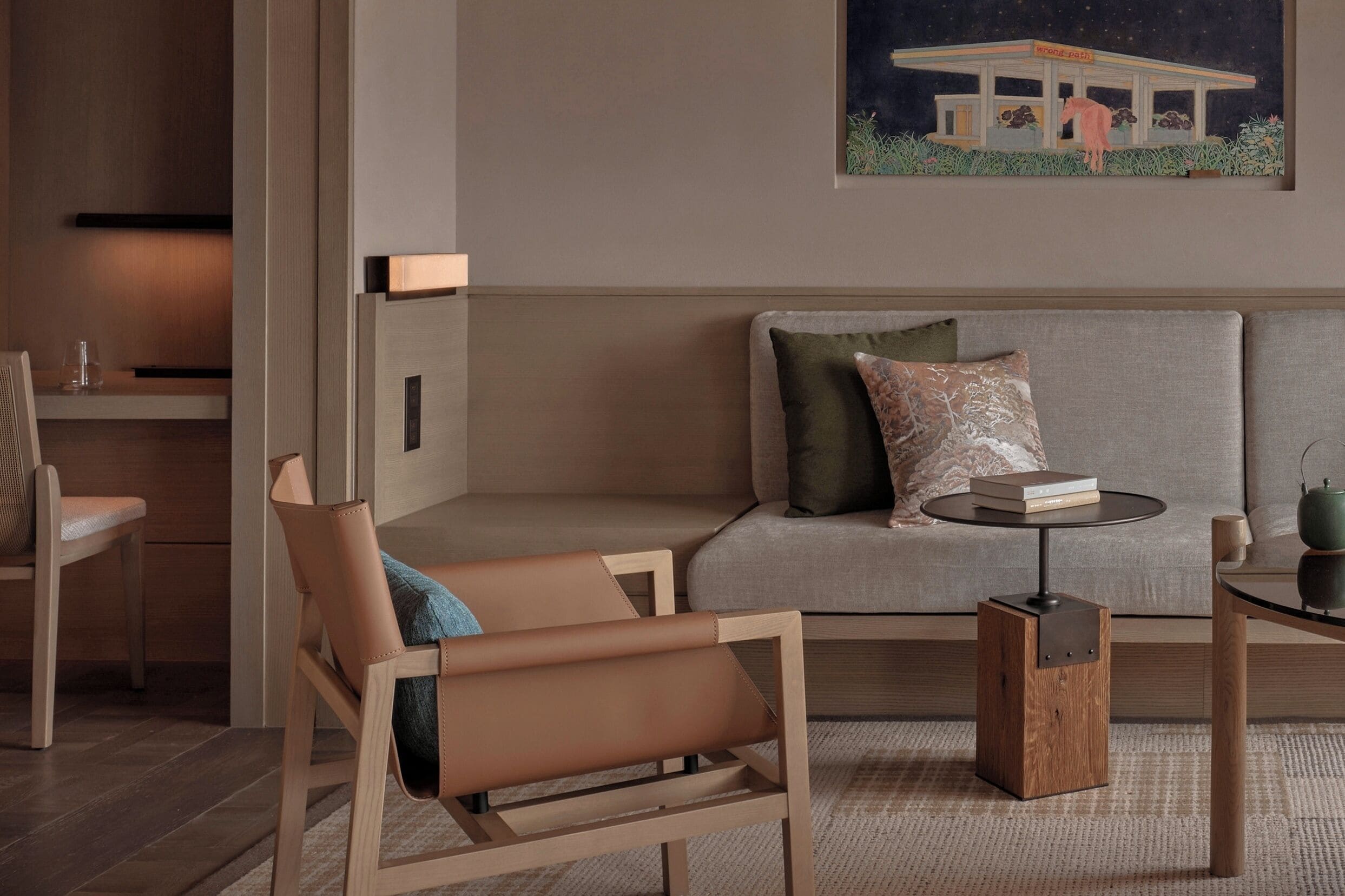 A modern living room with a sofa, a side table, and a chair.