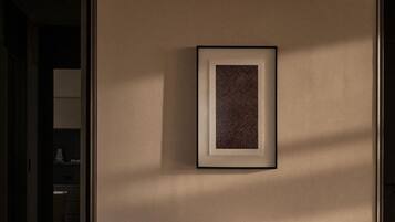 A framed artwork on a wall.