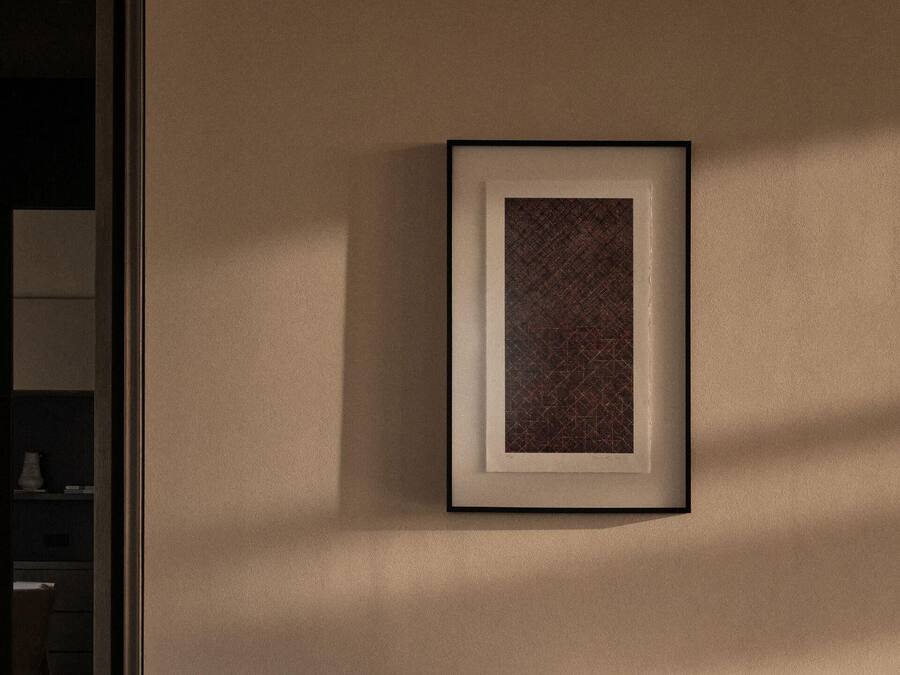 A framed artwork on a wall.