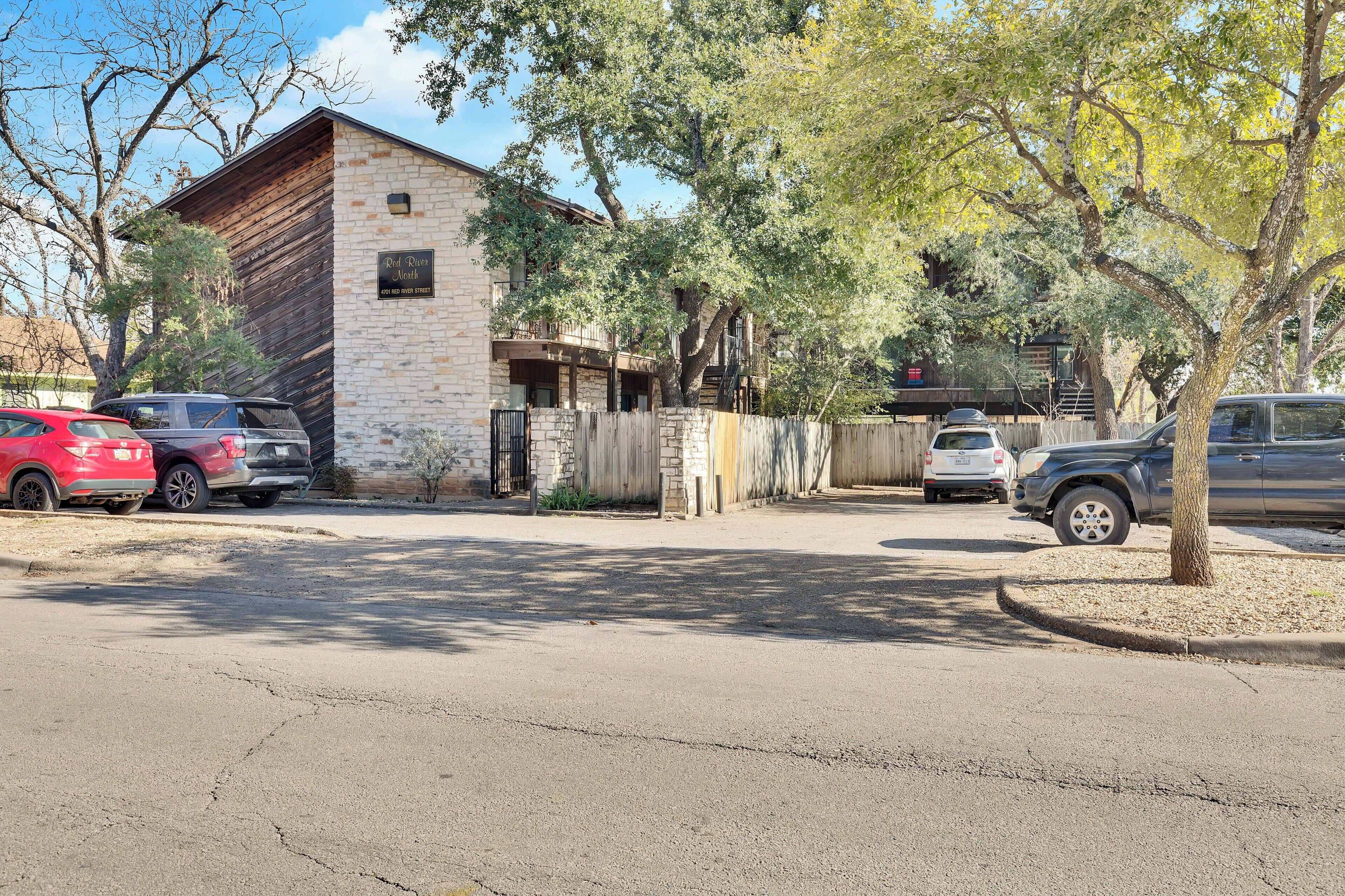 A two-story building with a stone facade and a wooden roof.
