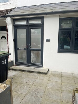 Welcome to 8-8A Grenaby Avenue, where a sleek front door with a glass panel invites you in.