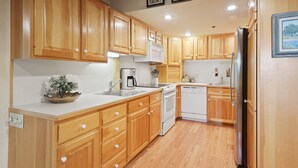 A kitchen with wooden cabinets, a white countertop, and stainless steel appliances. - Stonebridge Condos #717 2 Bedrooms, 2 Baths, 2 Fireplaces (Snowmass Village)