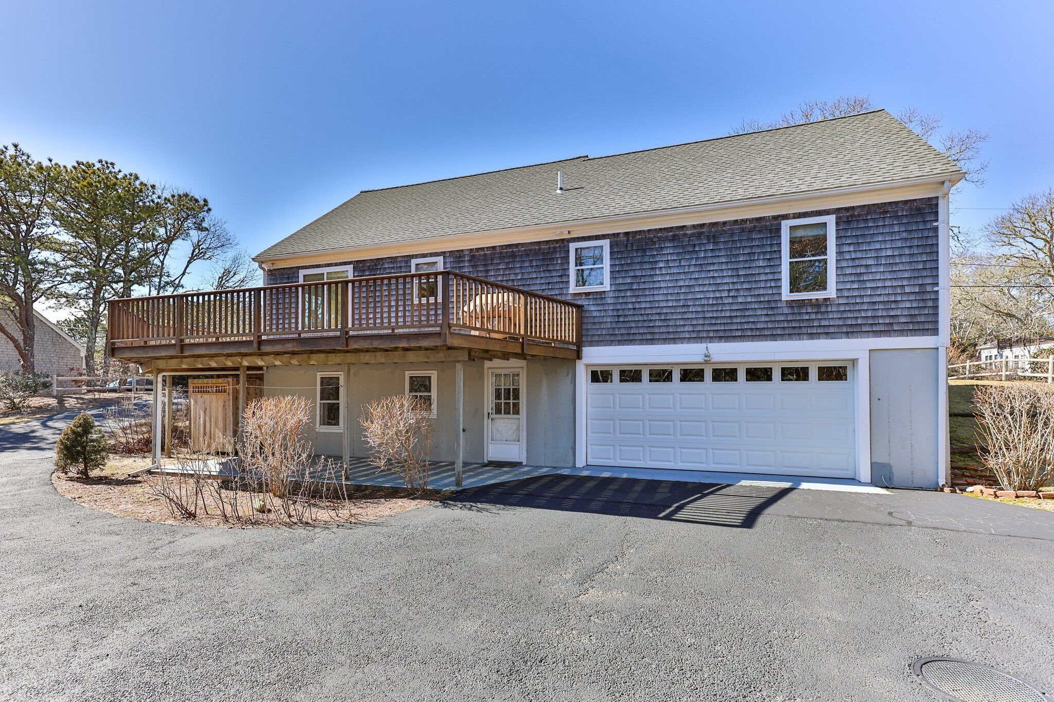 A two-story house with a covered porch and a garage.