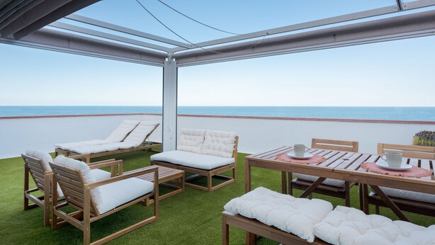 An outdoor patio with wooden furniture and a view of the ocean. - Casa Checha Charming Penthouse With Breathtaking Views (Candelaria)
