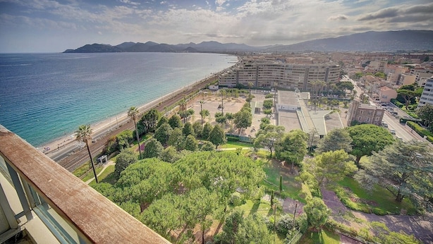 Un paisaje urbano costero con vista al mar, una playa y un gran complejo hotelero.