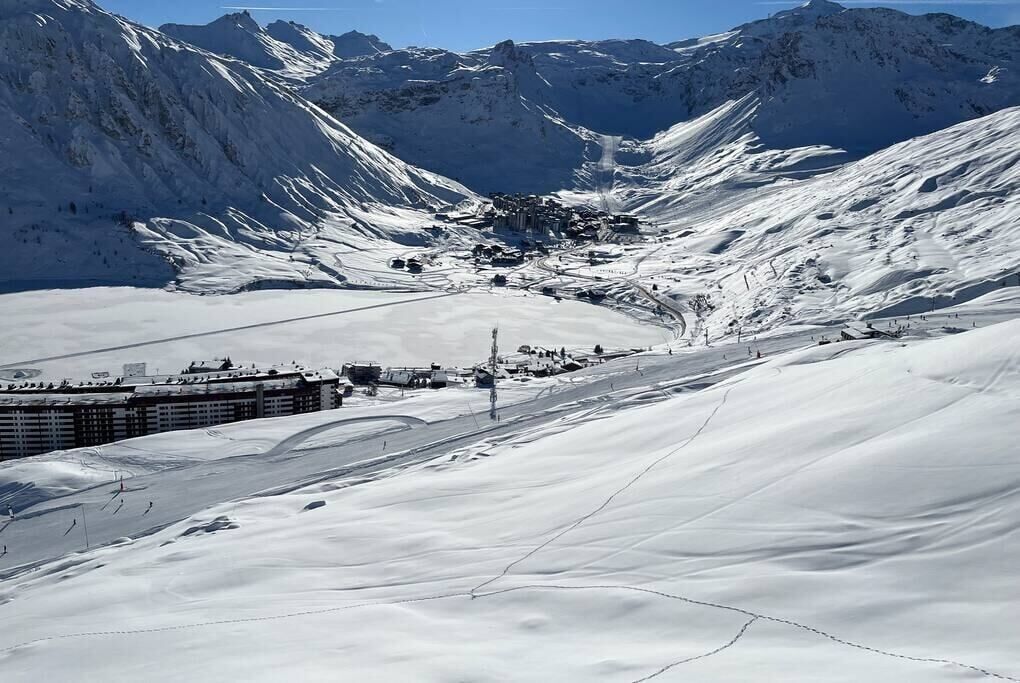 A snow-covered mountain landscape with a ski resort.