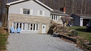 A two-story house with a stone facade, a garage, and a gravel driveway. - Work crews welcome! near the I-71/Rt 13 and I-71/Rt 39  easy access to Mansfield (Mansfield)