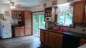 A kitchen with wooden cabinets, a white refrigerator, a microwave, and a red sink. - Work crews welcome! near the I-71/Rt 13 and I-71/Rt 39  easy access to Mansfield (Mansfield)