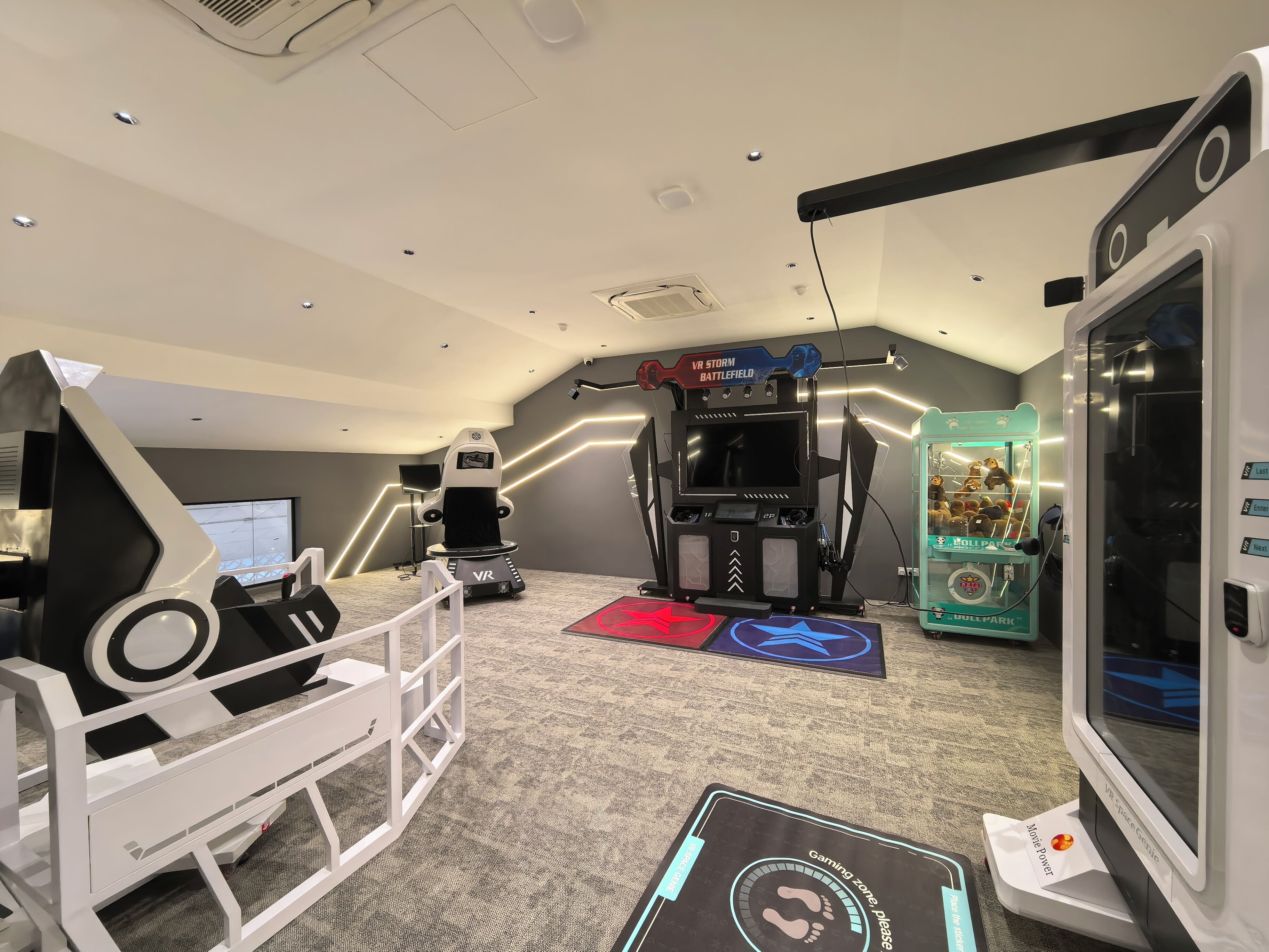 A VR gaming room with a VR chair, a treadmill, and a VR boxing machine.