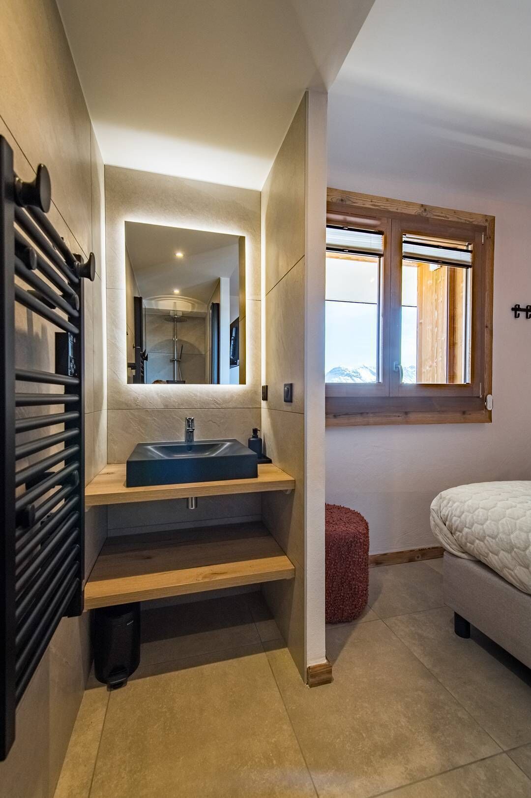 A modern bathroom with a built-in sink, a mirror, and a shower.