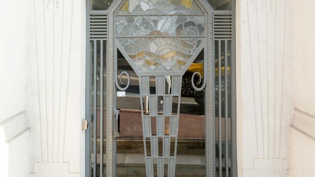A building entrance with ornate architectural details and a sign reading "PALAISE EXANOR EIII". - 3 Bedroom Apartment in Heart of Cannes (Cannes)